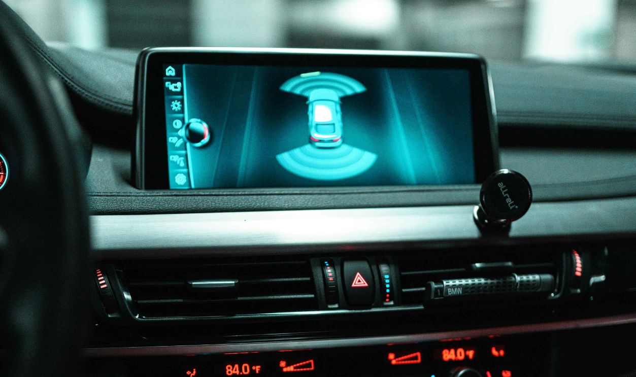Close-up of a car dashboard with a digital screen and controls