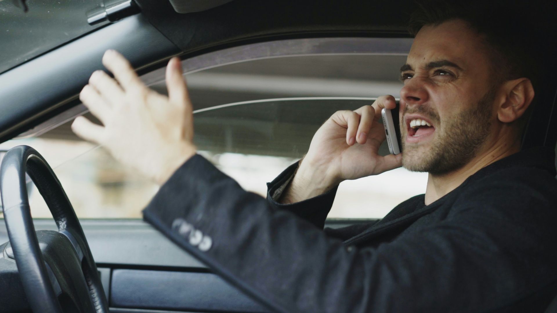 Man talking on phone while driving car