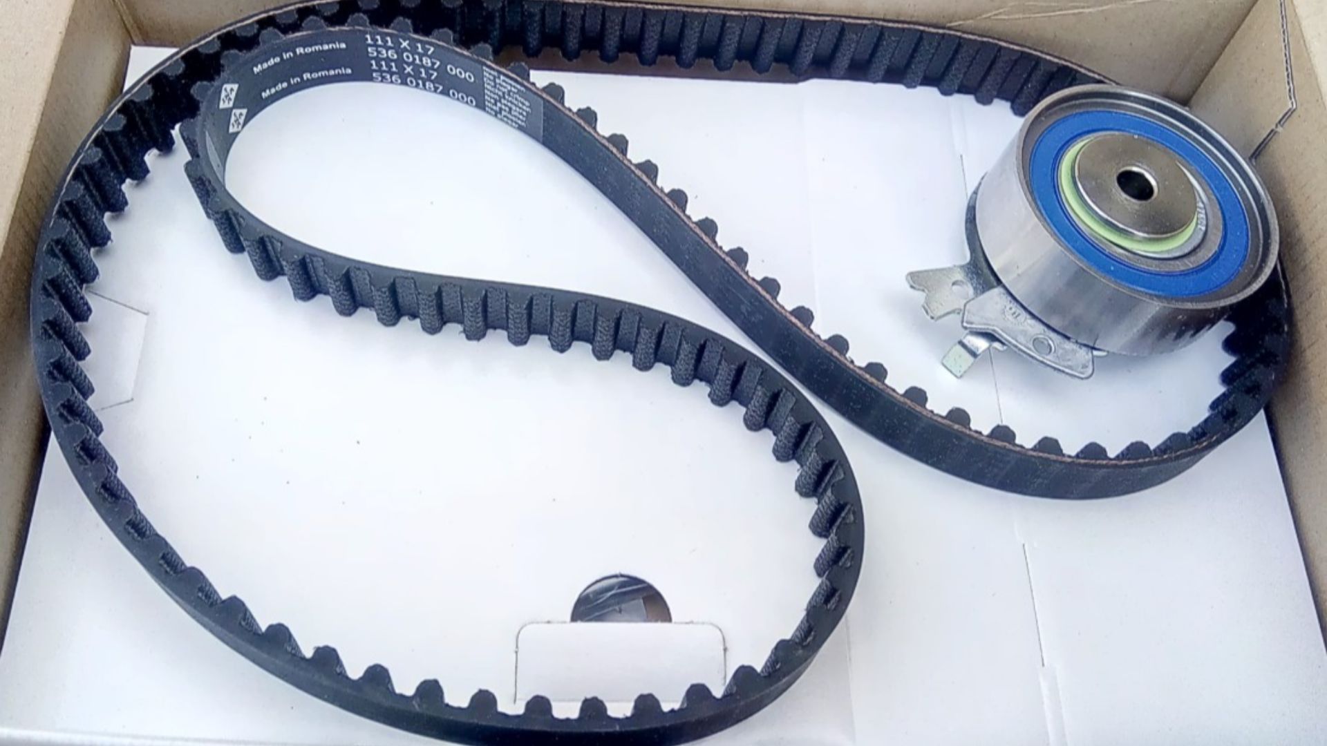 Timing belt with attached automatic tensioner.