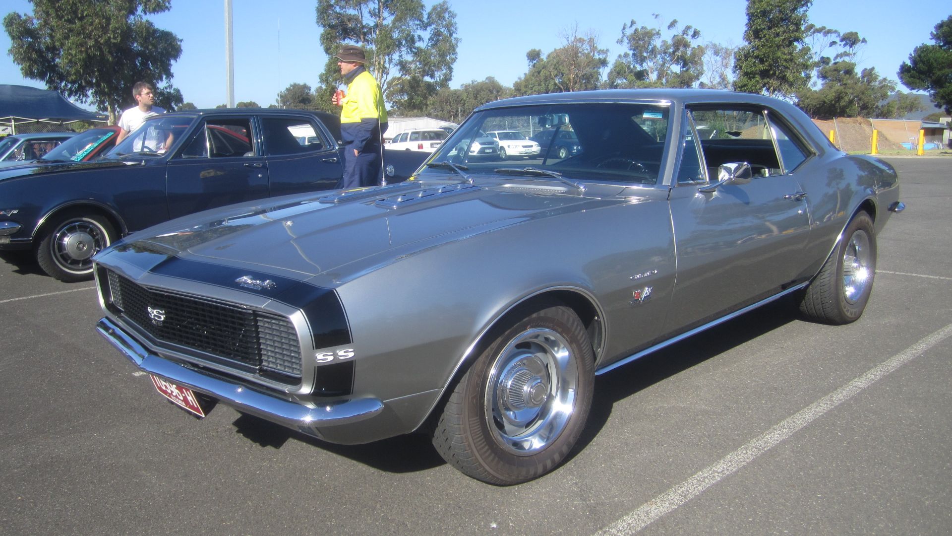 A F body Pony Car, introduced in Sept 1966, direct competition for the Mustang, shared platform and components with the Firebird.
Available in base, RS appearance package, SS performance package and race ready Z28 designed to compete in the SCCA Trans Am Series. 
This car has both the RS and SS package. 
The SS performance package got either the 350 or 396 cu in V8, better suspension, striping , SS badges and non functional air intakes on the hood.

With the RS appearance package you got the hidden headlights, revised tail lights with back up lights under the bumper, rocker trim and RS badging.