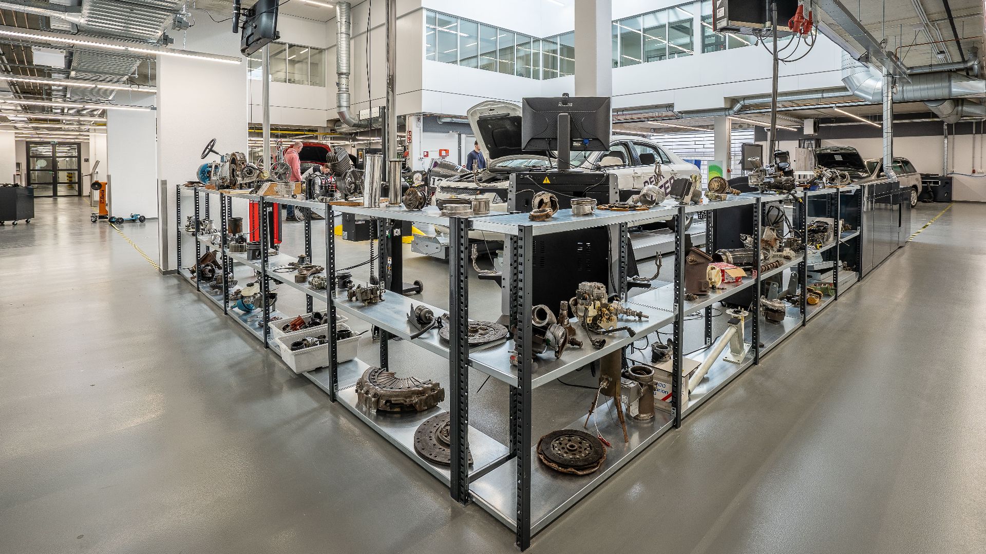 Spacious auto workshop showcasing various car parts and repair equipment.