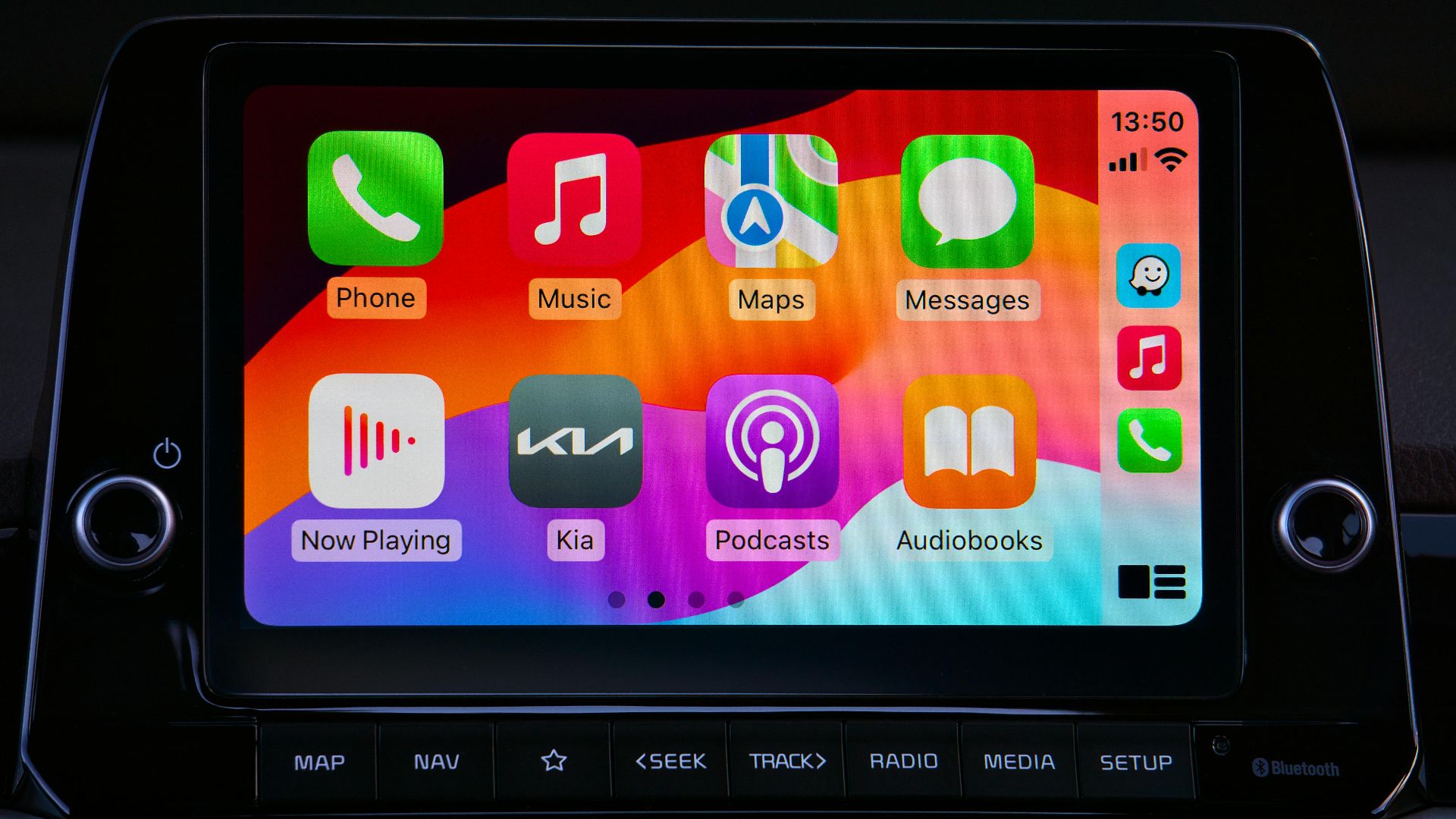 Close-up of a car's modern touchscreen display showcasing various app icons for enhanced in-car connectivity.