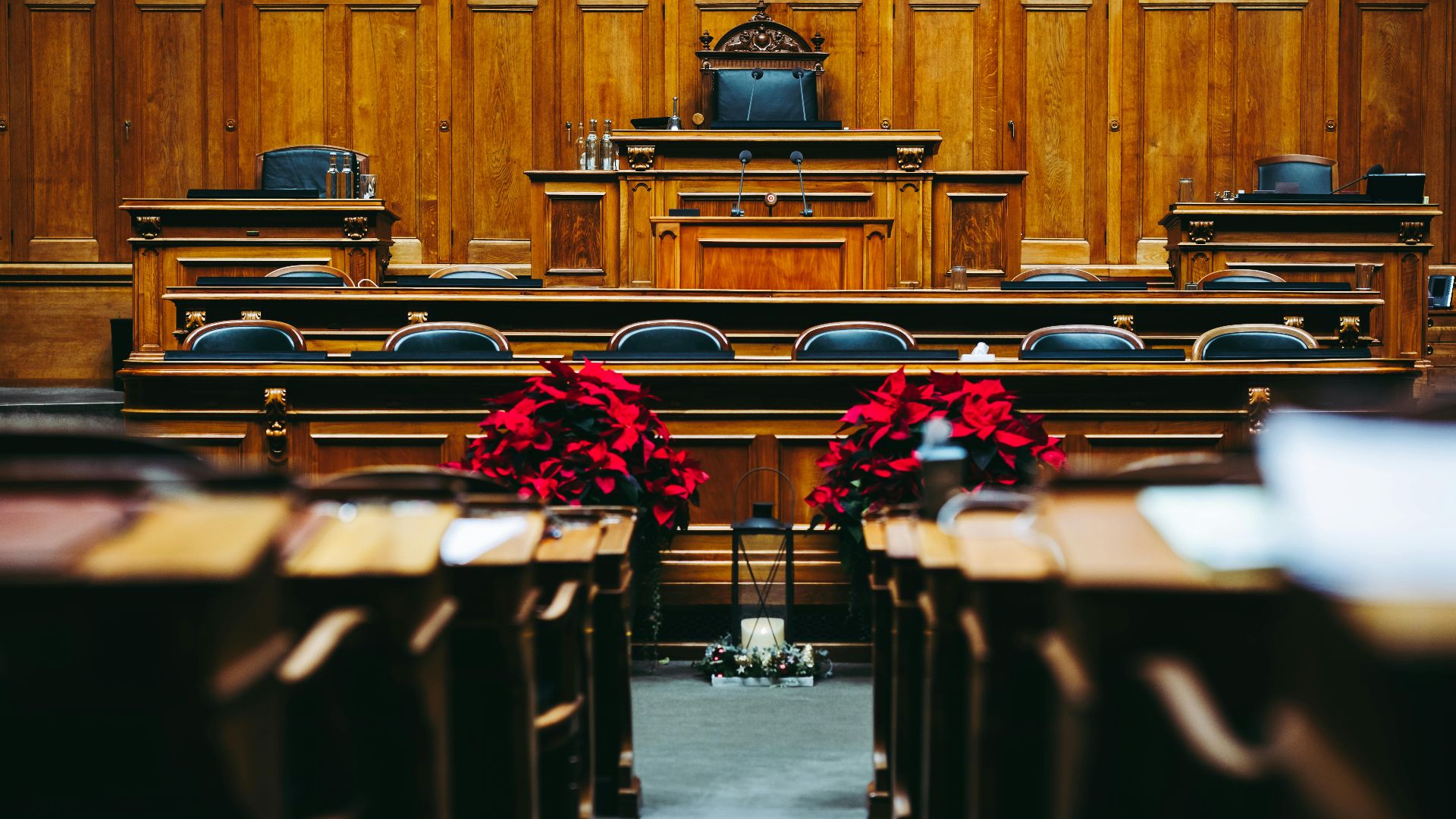 Spacious and elegant wooden courtroom with empty seats, located in Bern, Switzerland.