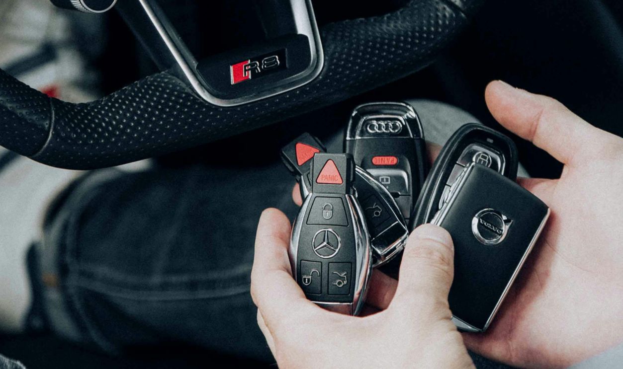 Detailed view of Audi car interior showcasing steering wheel and key fobs in hand for luxury vehicle lifestyle