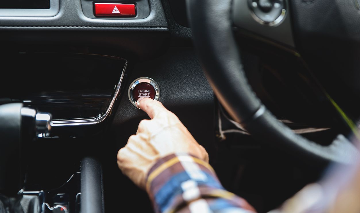 Close up Finger press button functions car engine start and stop in motor vehicle for pre start checklist concept.