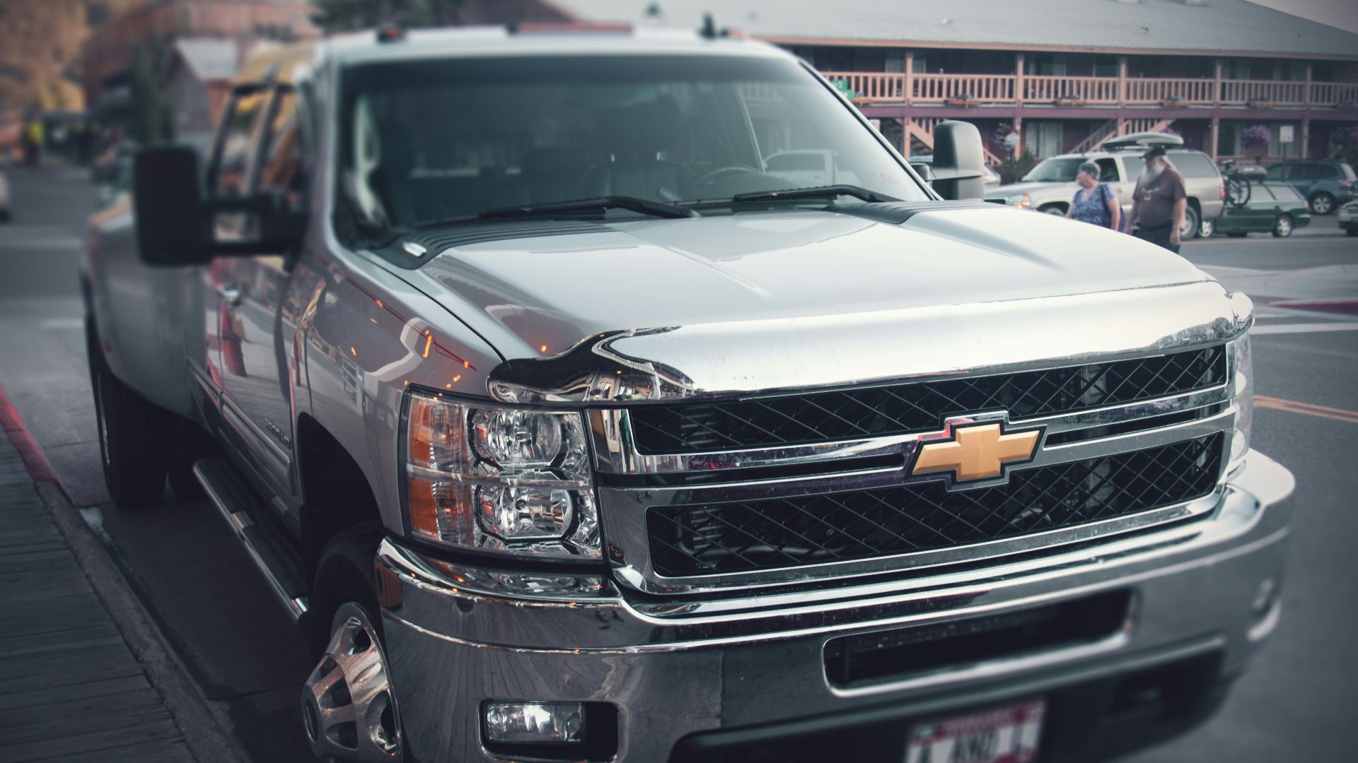 a silver truck parked on the side of the road