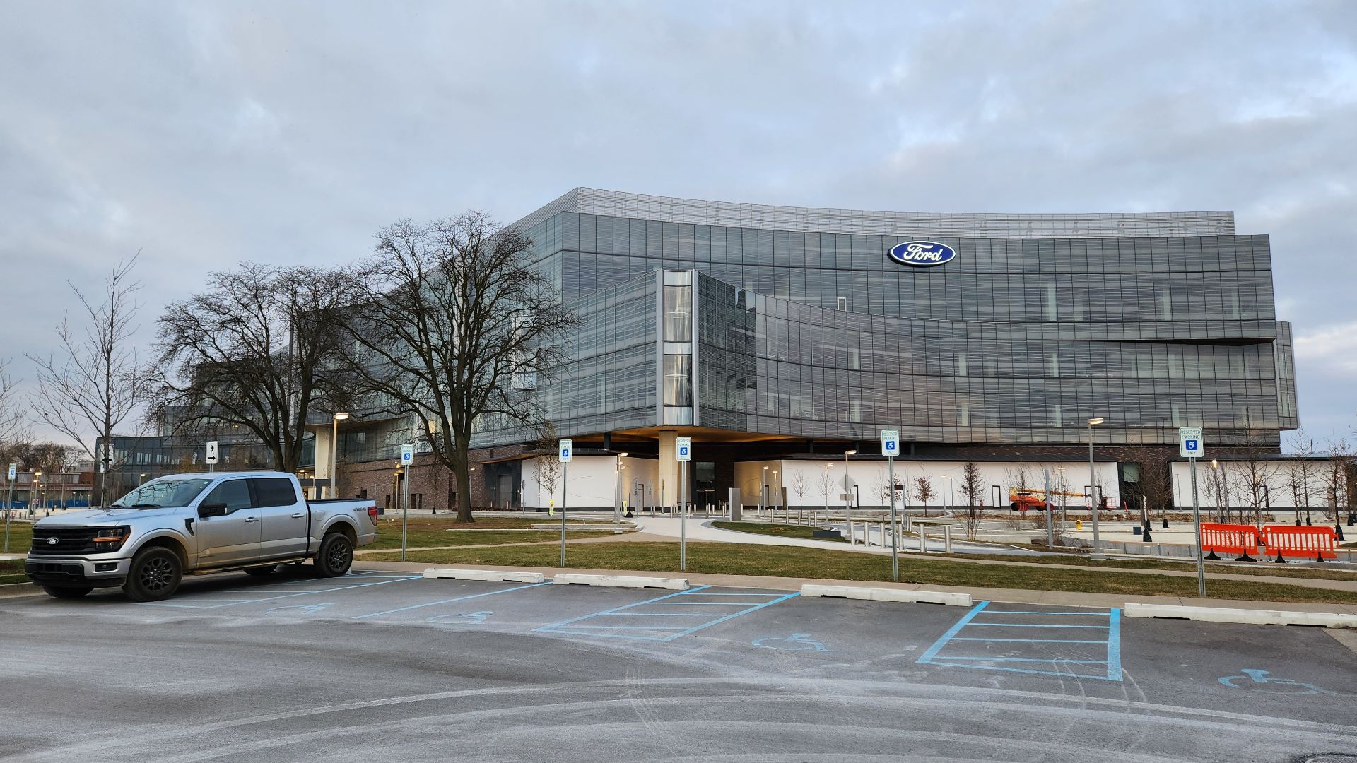 Exterior of the new Ford World Headquarters in Dearborn, Michigan; in the foreground is a Ford F-150 pickup truck, the Ford Motor Company's most popular product.