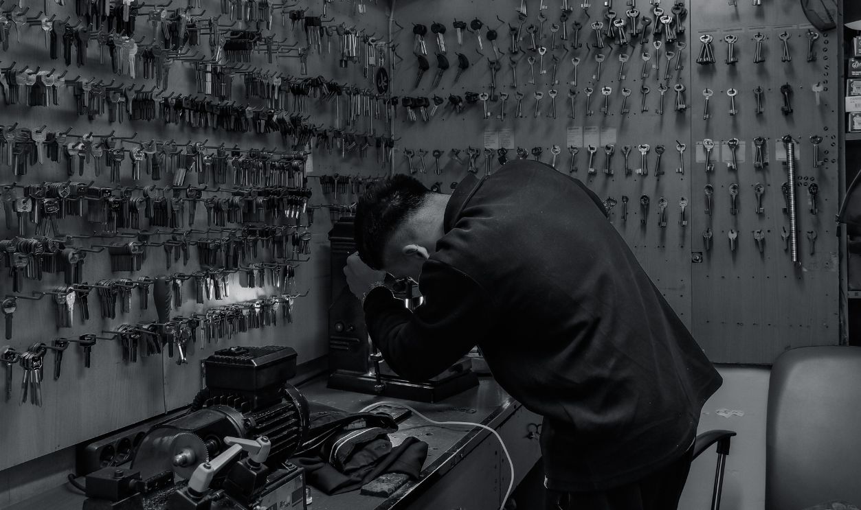 A locksmith at work in a shop full of keys in Istanbul, Turkiye