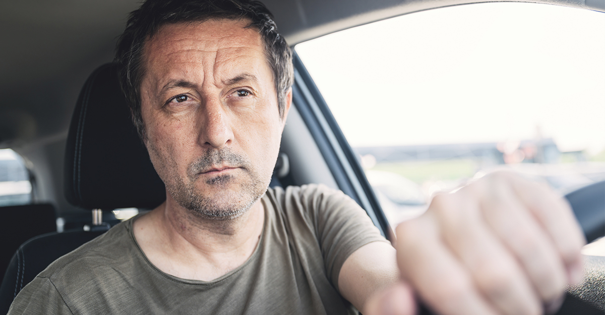 Middle-aged man driving.