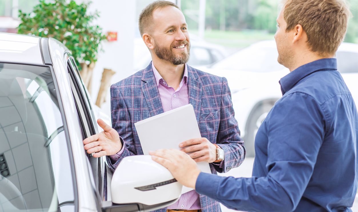 Shutterstock-771176119, Professional car dealer talking to his client at the delaership helping mature man choosing a new automobile vehicle transportation travelling comfort safety luxury investment insurance discount.