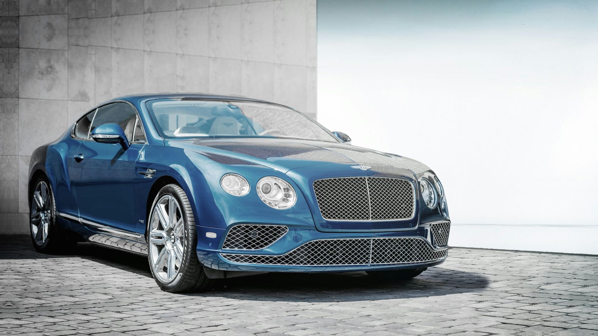 blue coupe on road