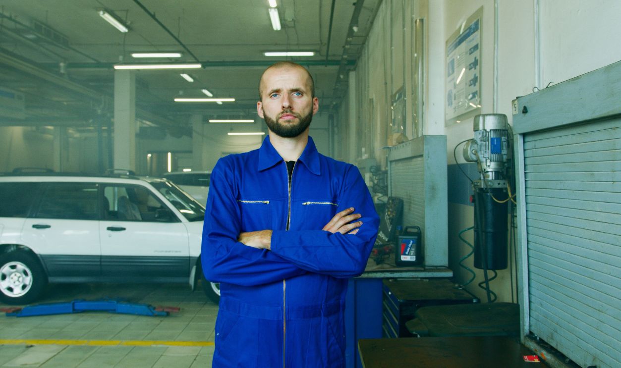 Professional mechanic in a repair shop, focused on car maintenance