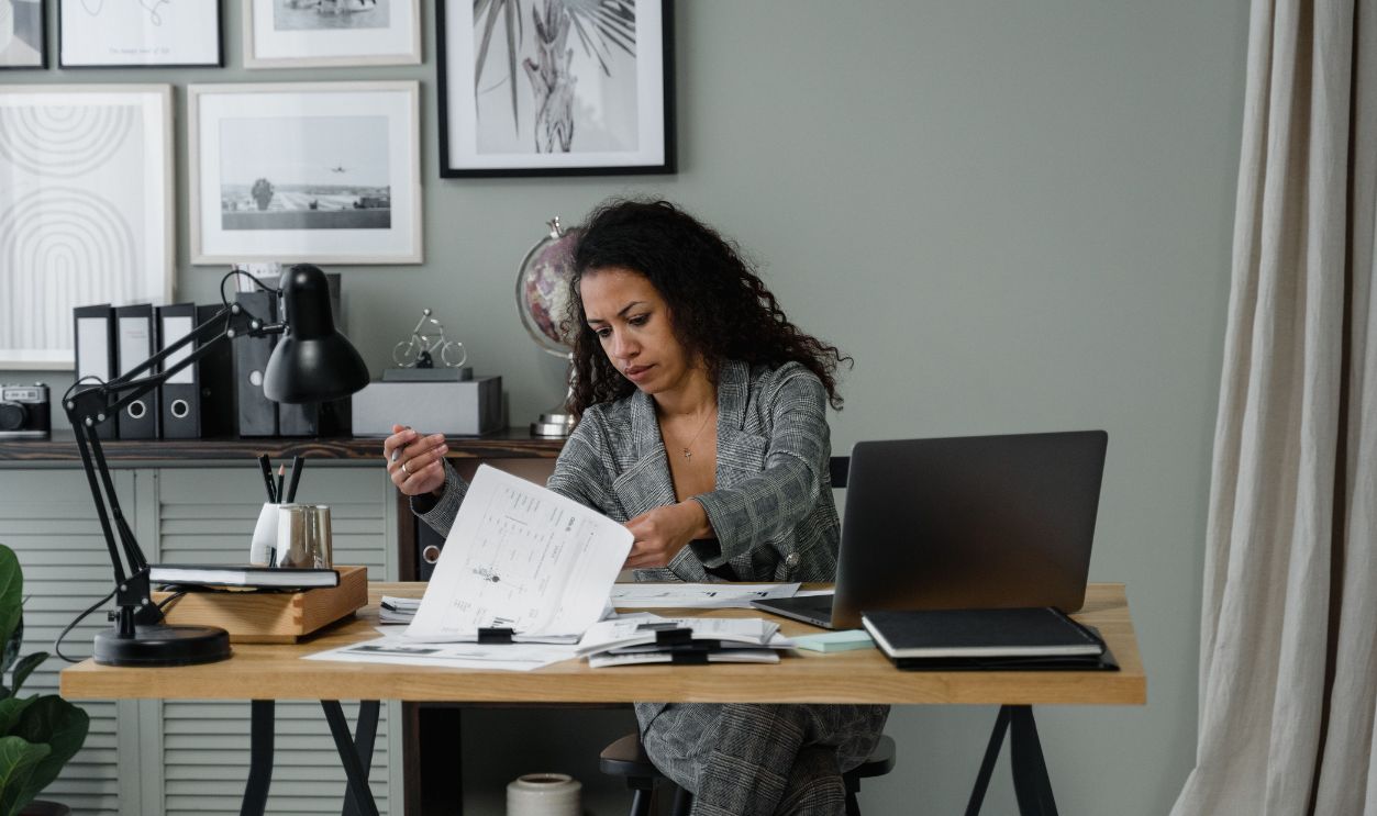 Professional woman working at a desk in a stylish home office setting