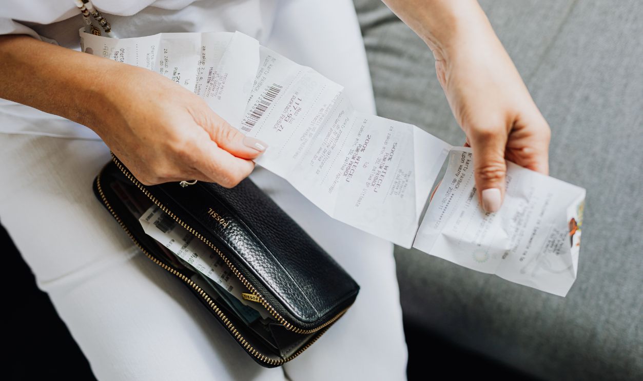 Close-up of a woman's hands managing multiple receipts