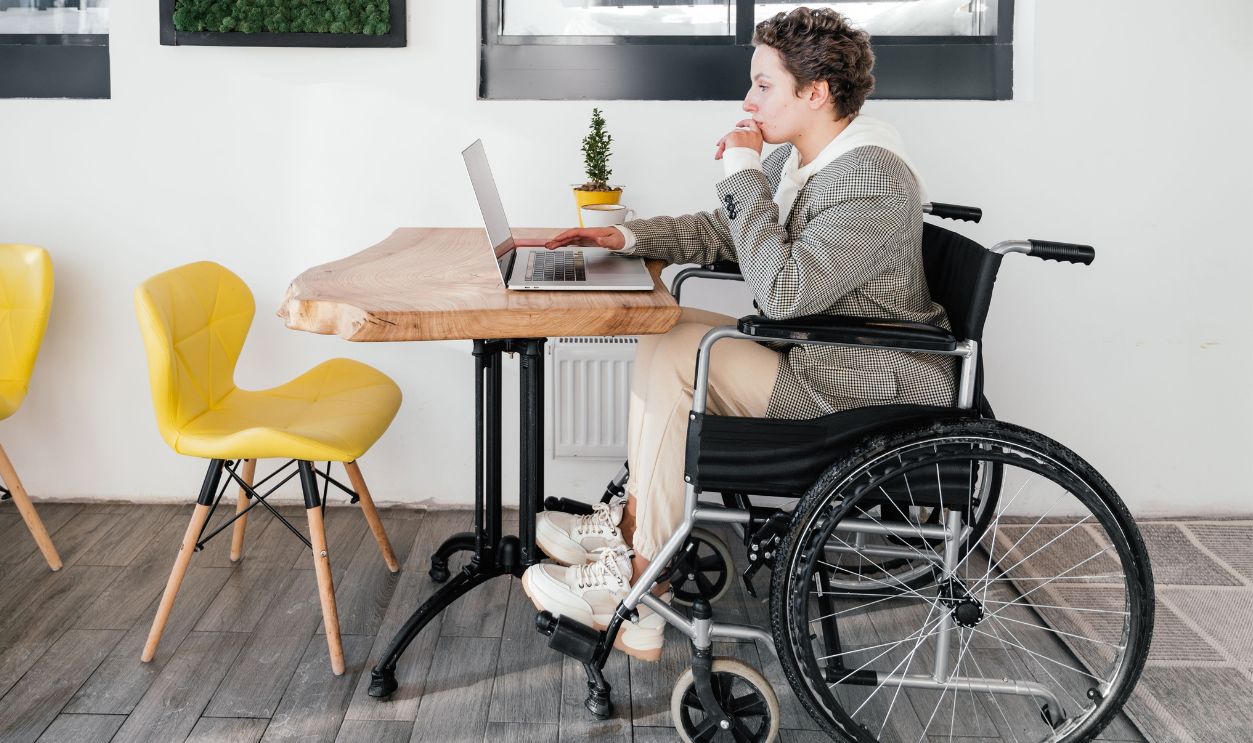 Woman in wheelchair working remotely on laptop