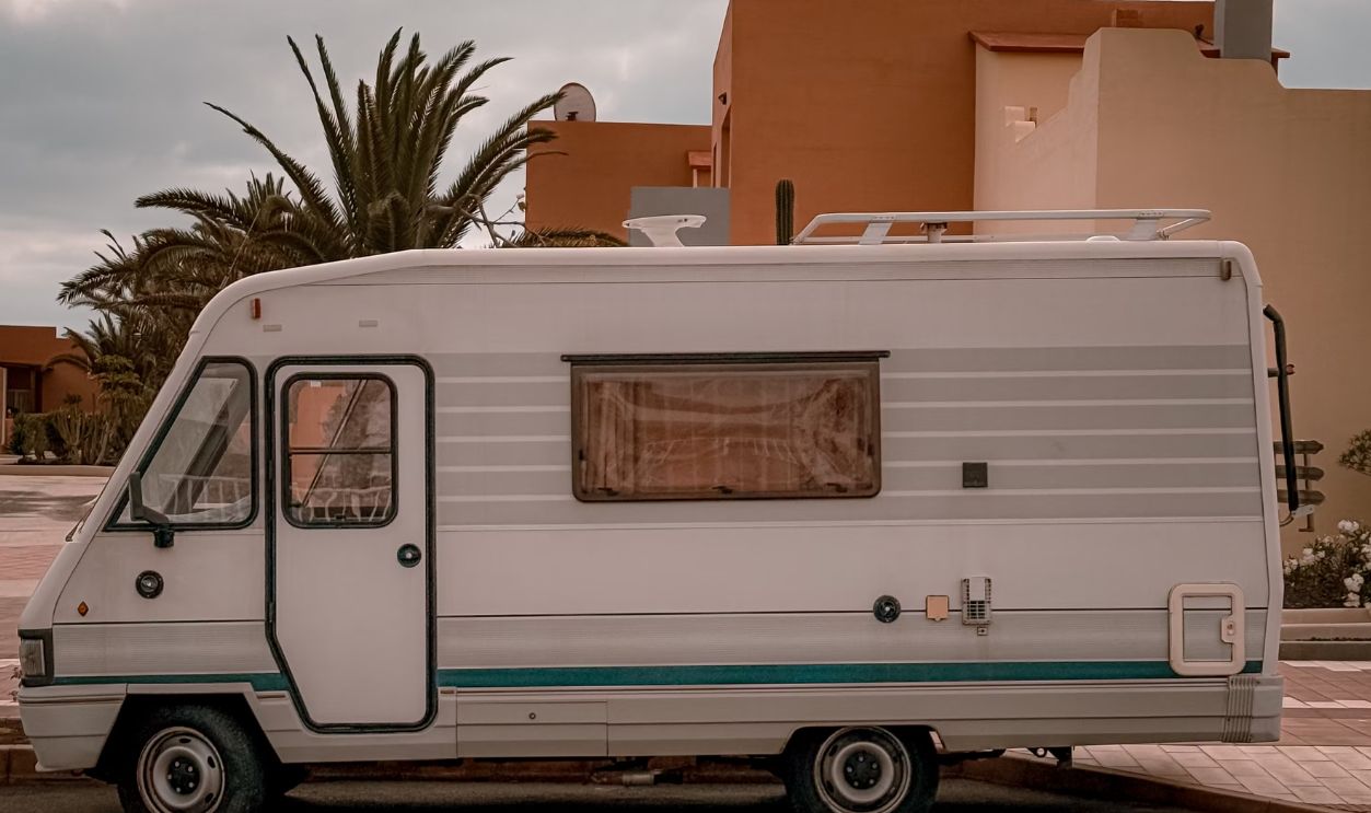 A classic camper van parked on a street in the Canary Islands, embodying retro travel vibes