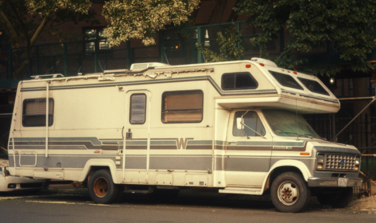 Classic Winnebago RV parked on a city street, exemplifying urban camping adventure