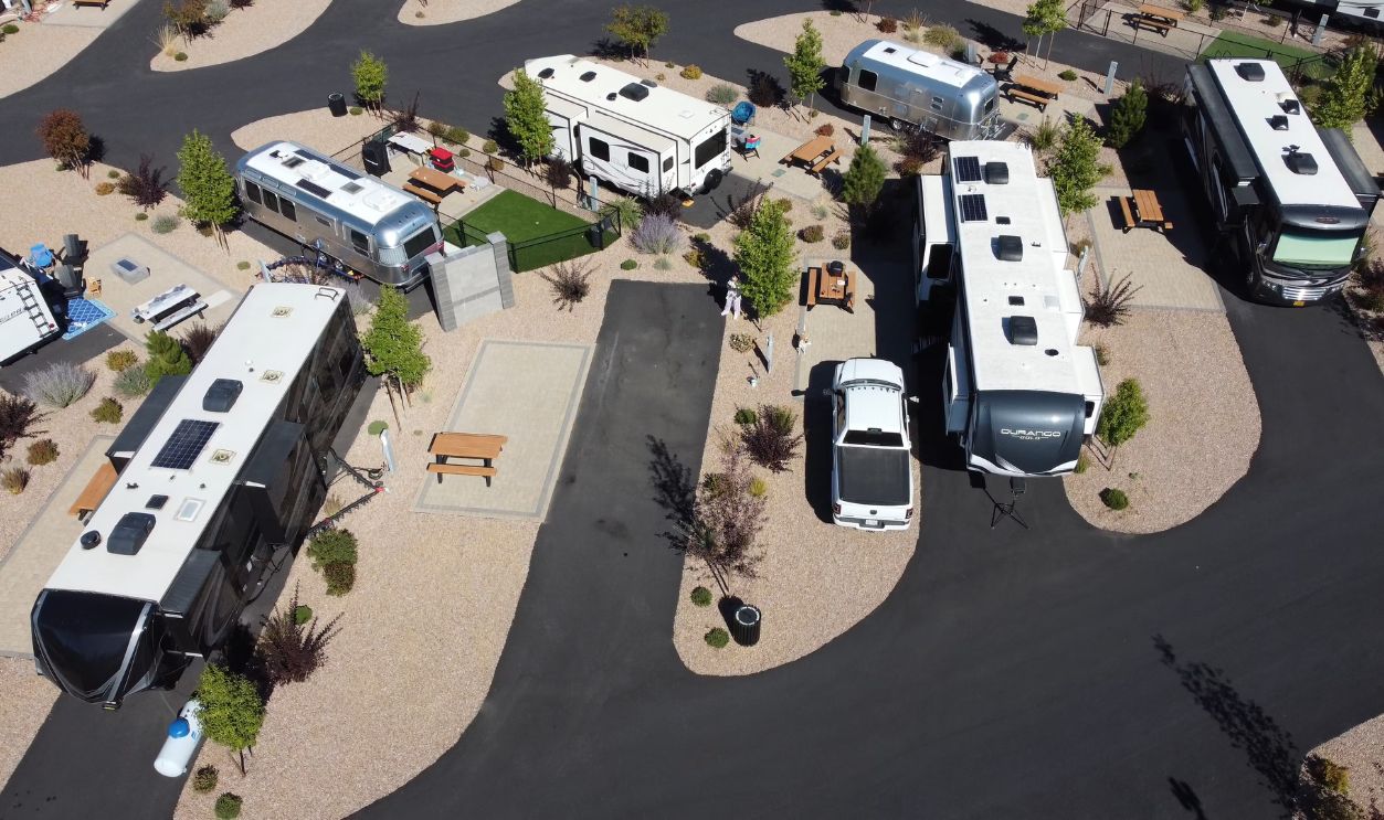 A scenic aerial shot showing a modern RV park with various campers and trailers