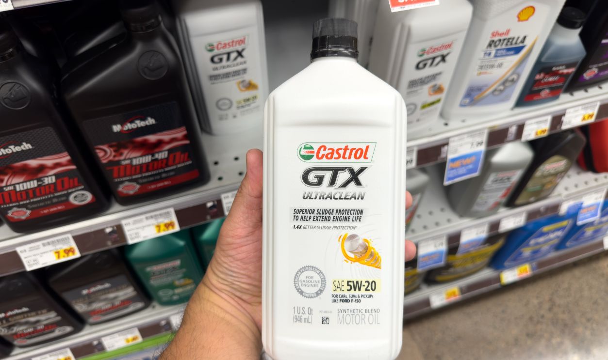 Los Angeles, California, United States - 05-05-2023: A view of a hand holding a bottle of Castrol GTX Ultraclean motor oil, on display at a local retail store.