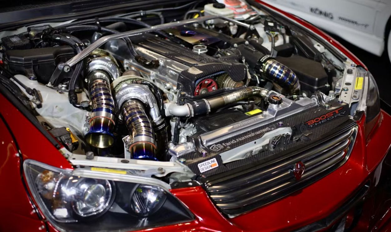High-performance red car engine with visible turbochargers and enhancements