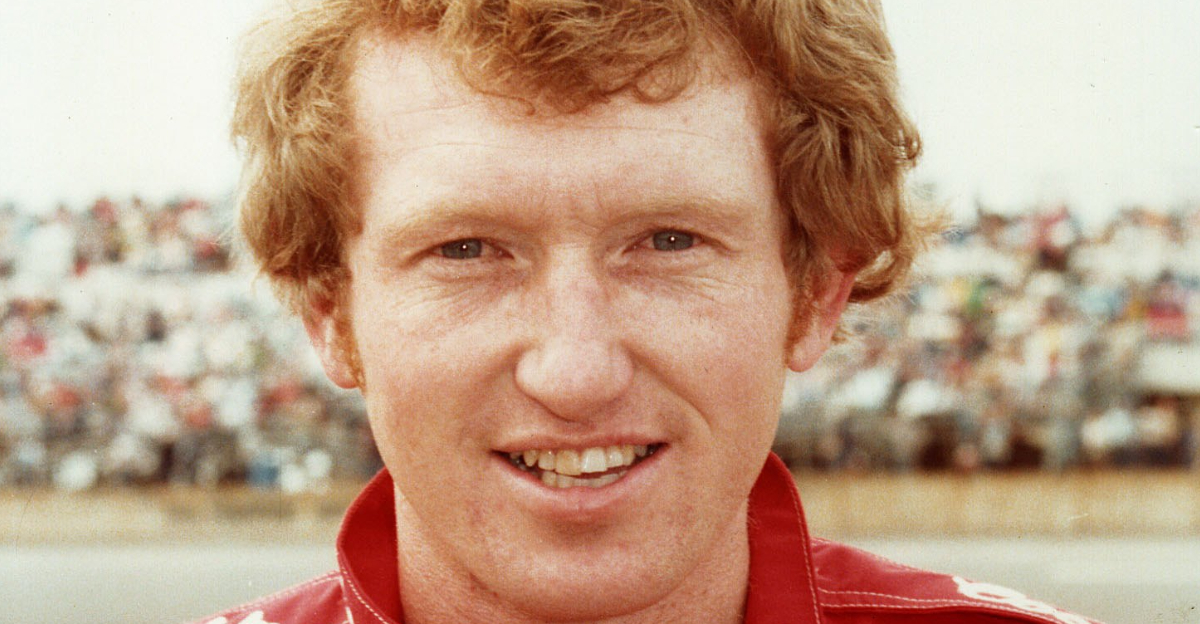Bill Elliott driver of the #9 Coors Ford looks on before a race circa 1986