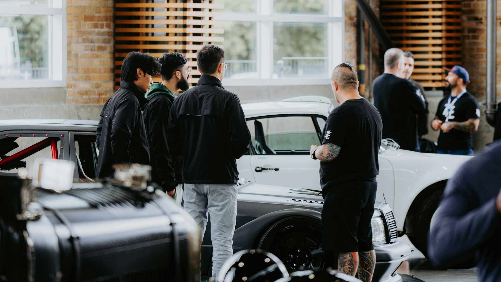 People are gathered around a classic car.