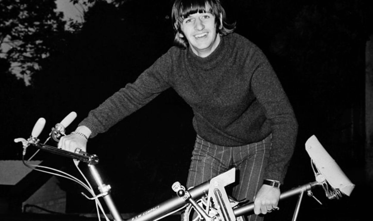 WEYBRIDGE, UNITED KINGDOM - CIRCA 1960: Ringo Starr unfolds his mini bike to go for a tour around the grounds of his mansion in Weybridge, United Kingdom, circa 1960.