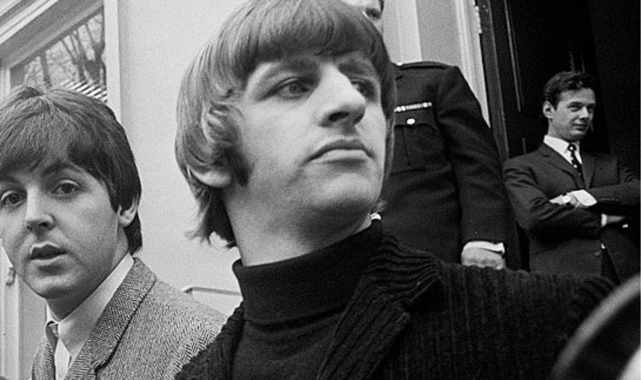 John Lennon passes his driving test in Weybridge Paul McCartney Ringo Starr and George Harrison are there to congratulate him 15 February 1965