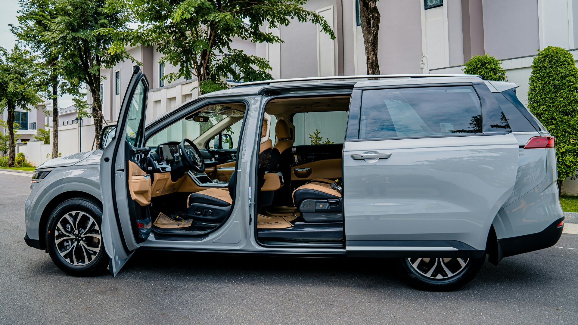 a silver minivan parked on the side of the road
