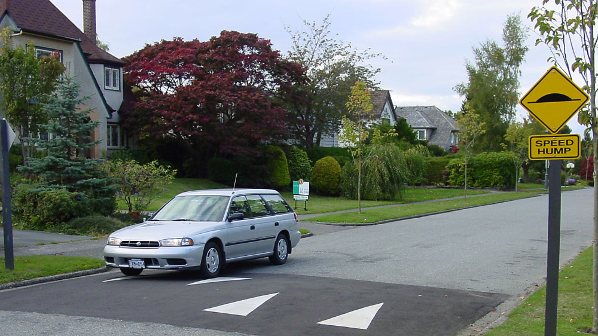 Speed hump with a Subaru Legacy Wagon (likely located in British Columbia, Canada)