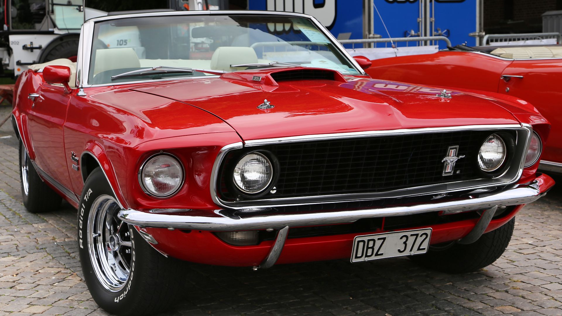 Ford Mustang Convertibles, model year 1969. Distinctive for this model, the outer headlights are set back in the fenders compared to the inner headlights. For trademark reasons, the Mustang was sold in Germany with the designation