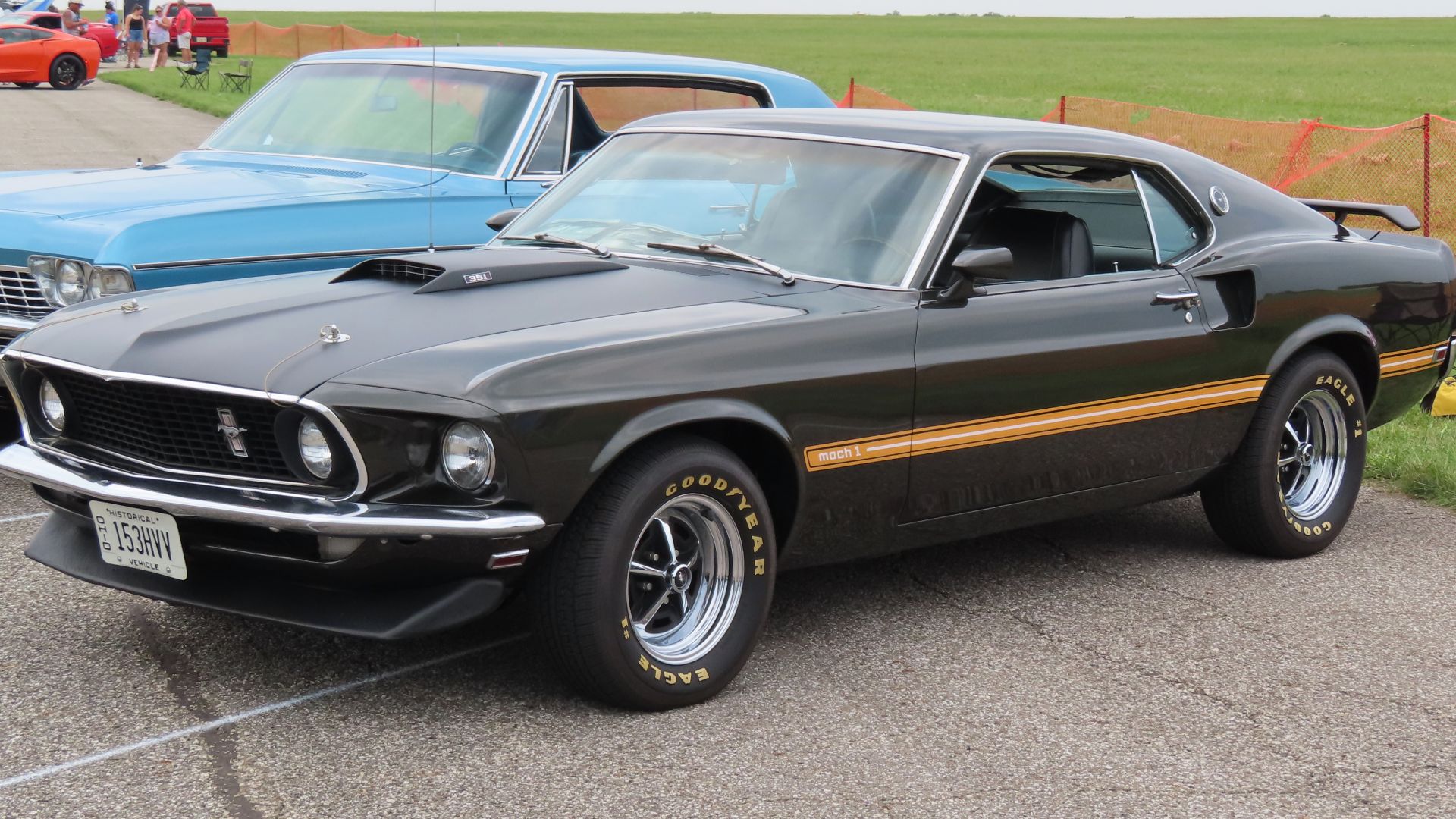 1969 Ford Mustang Mach I photographed at the 2023 Youngstown-Warren Regional Airport Wings-n-Wheels event in Vienna Center, Ohio. Finished in Black Jade Poly.