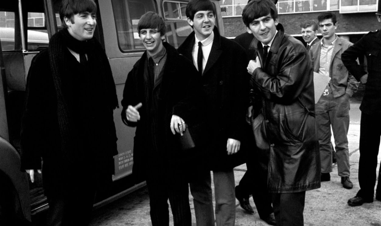 Left to right: John Lennon, Ringo Starr, Paul McCartney and George Harrison at Heathrow Airport before flying out for a series of engagements in Sweden.