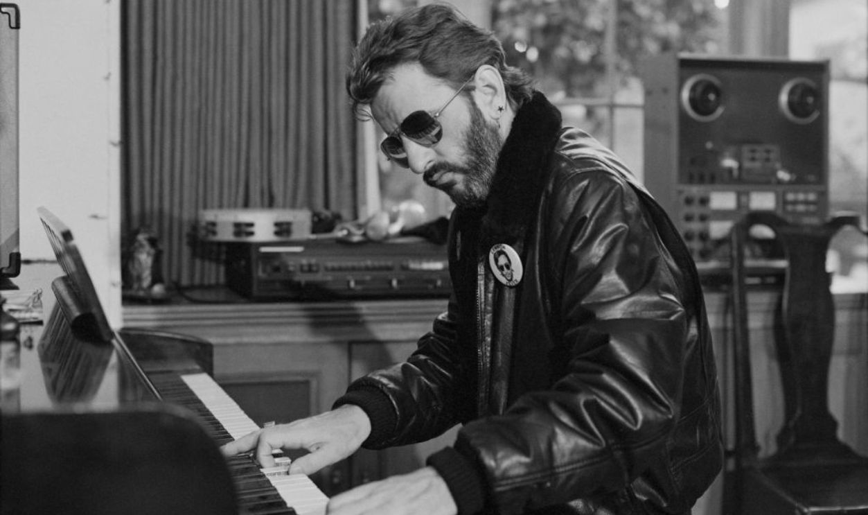 Ringo Starr playing piano at home.