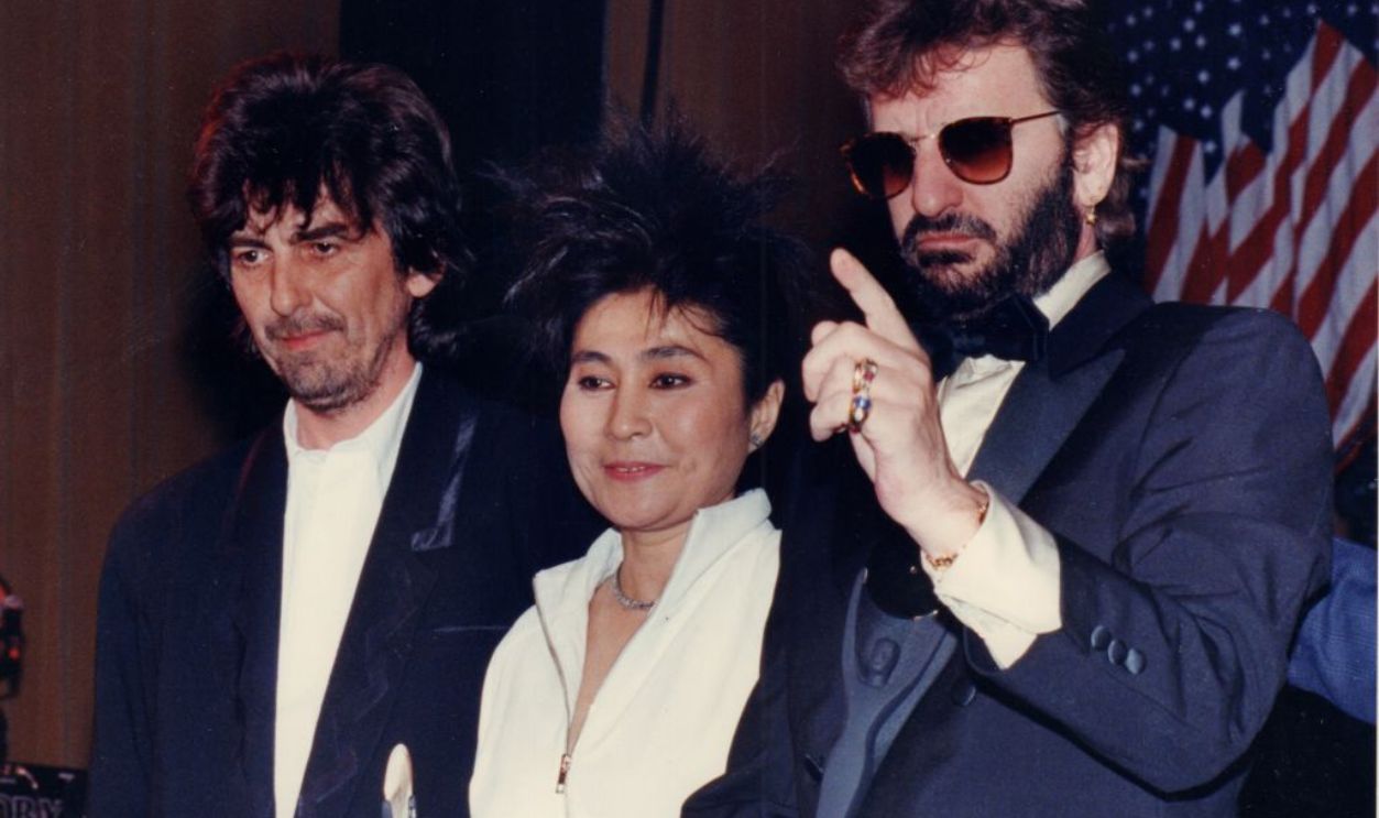 New York, N.Y.: The Beatles' George Harrison (left) and Ringo Starr (right) are inducted into the Third Annual Rock and Roll Hall of Fame held at the Waldorf-Astoria Hotel's Grand Ballroom in Manhattan, New York on January 20, 1988. Yoko Ono accepts the statue for her deceased husband John Lennon, and band member Paul McCartney missed the induction ceremony because of business differences with Harrison and Starr.