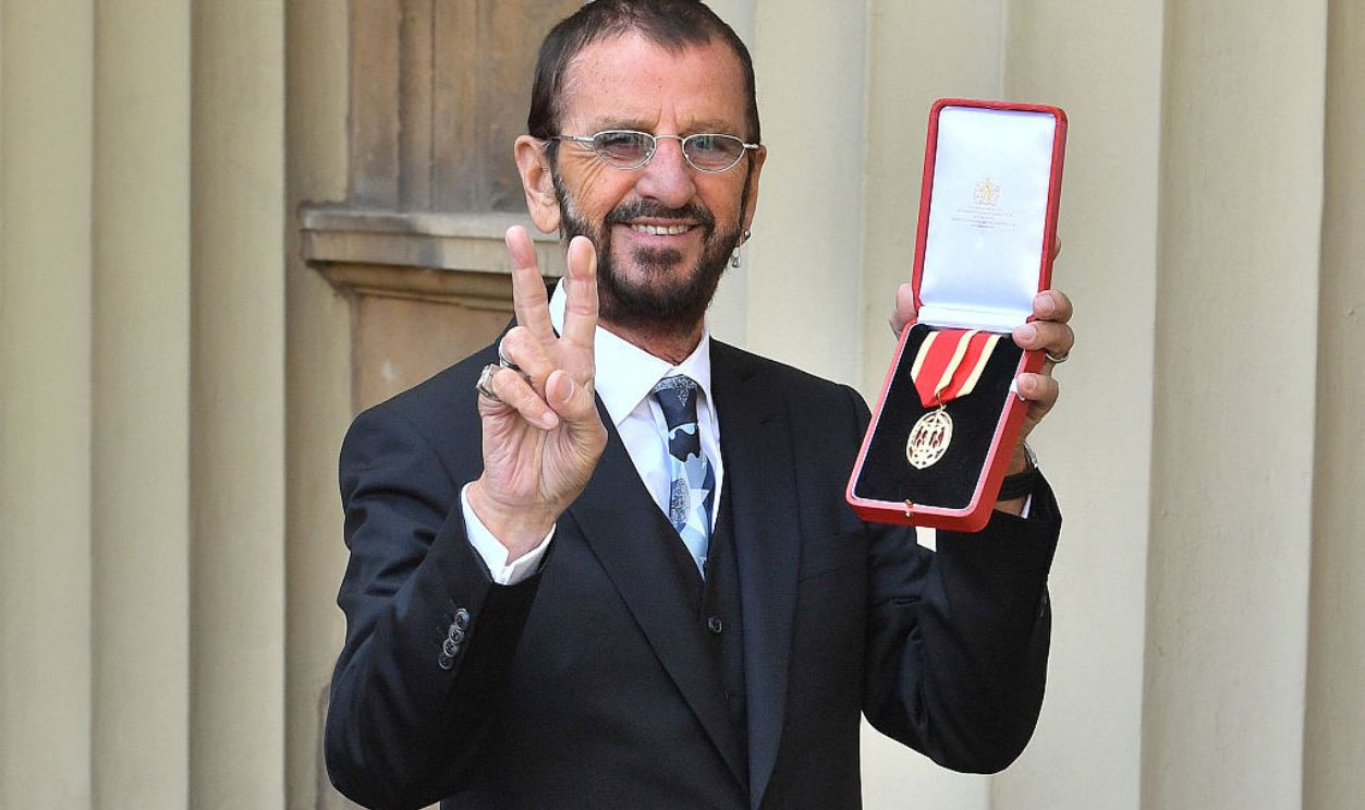 TOPSHOT - Richard Starkey, better knonwn as Ringo Starr, poses with his medal after being appointed Knight Commander of the Order of the British Empire at an investiture ceremony at Buckingham Palace in London on March 20, 2018.