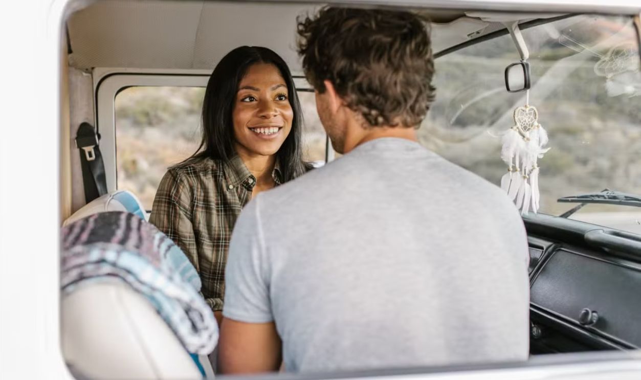 Couple Talking Calmly Beside a Car