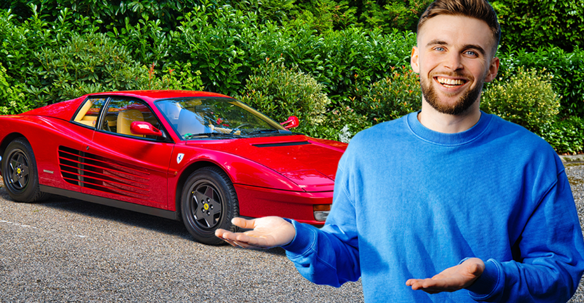 Man with arms raised, in front of Ferrari Testarossa