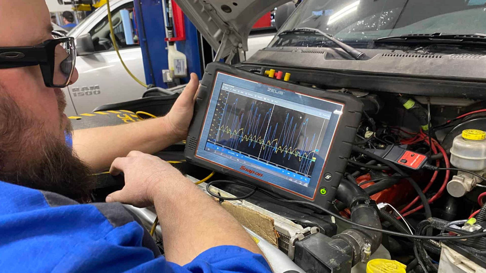 A man is diagnosing a electronic vehicle system