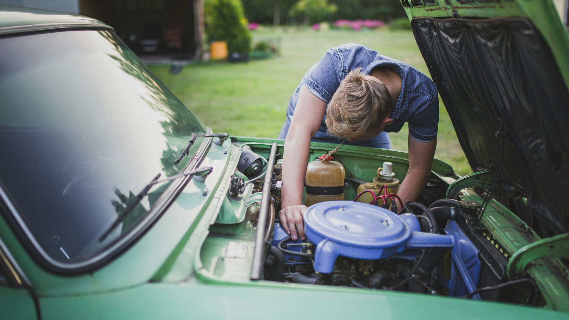 man checking vehicle engine
