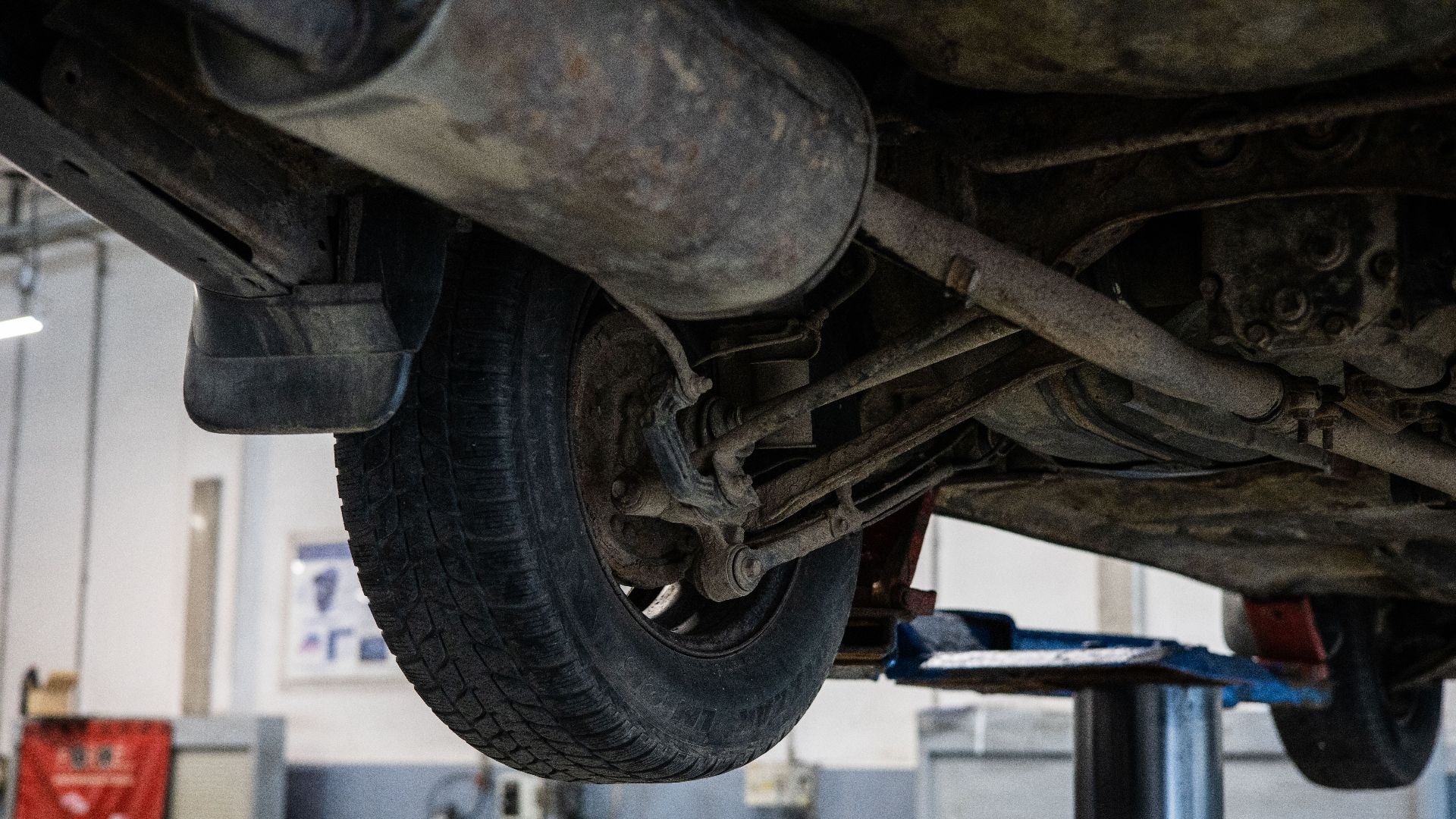Close-up of car's undercarriage in a service station for repair and maintenance.