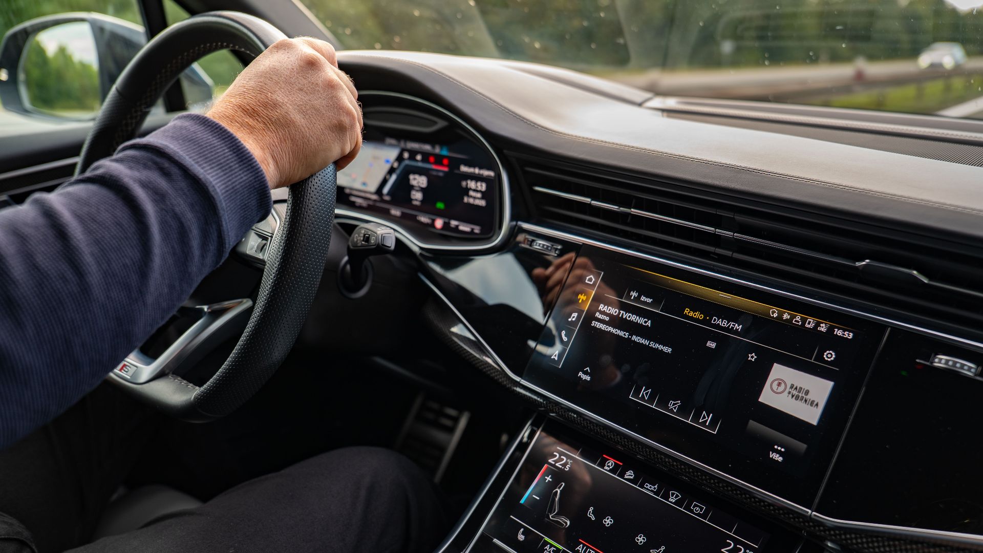 Interior view of a modern car being driven in Osijek, highlighting the dashboard and entertainment system.