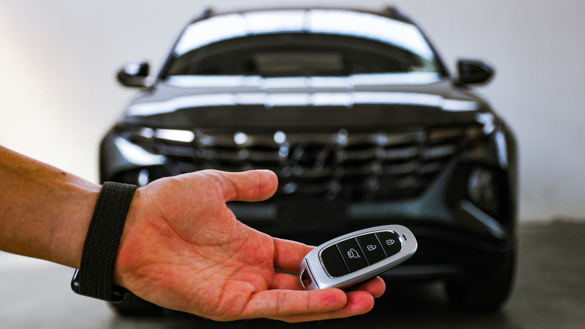 person holding black and silver audi car steering wheel