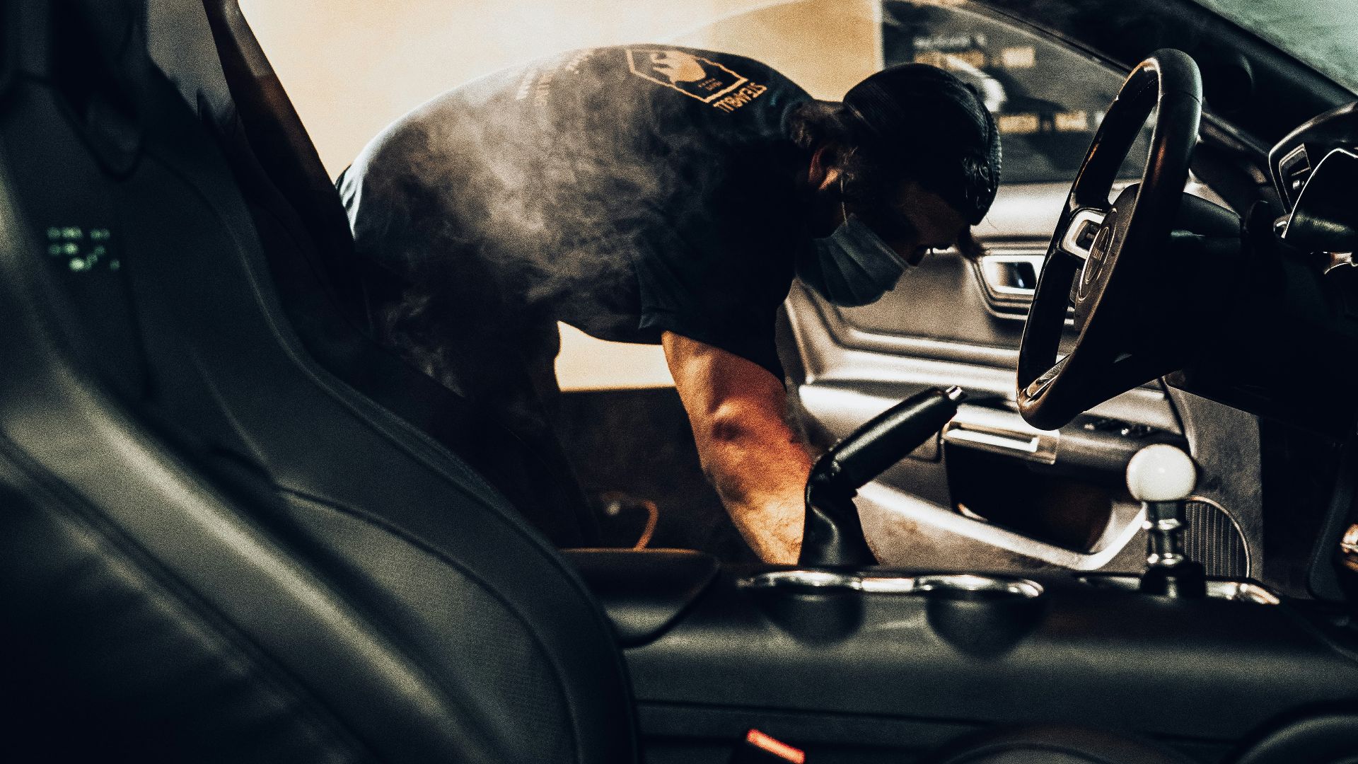 man in black t-shirt driving car