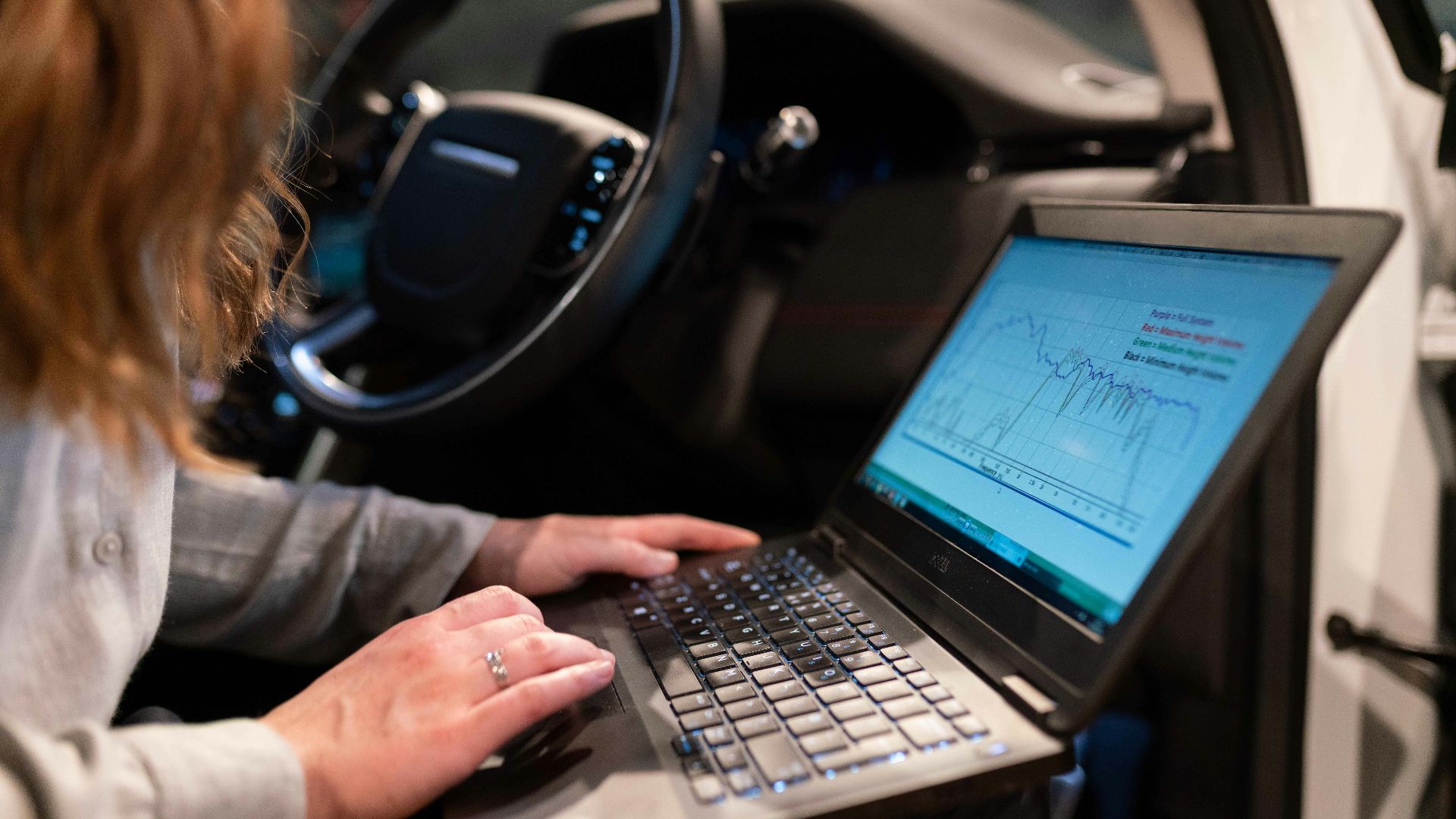 woman in gray long sleeve shirt using black laptop computer