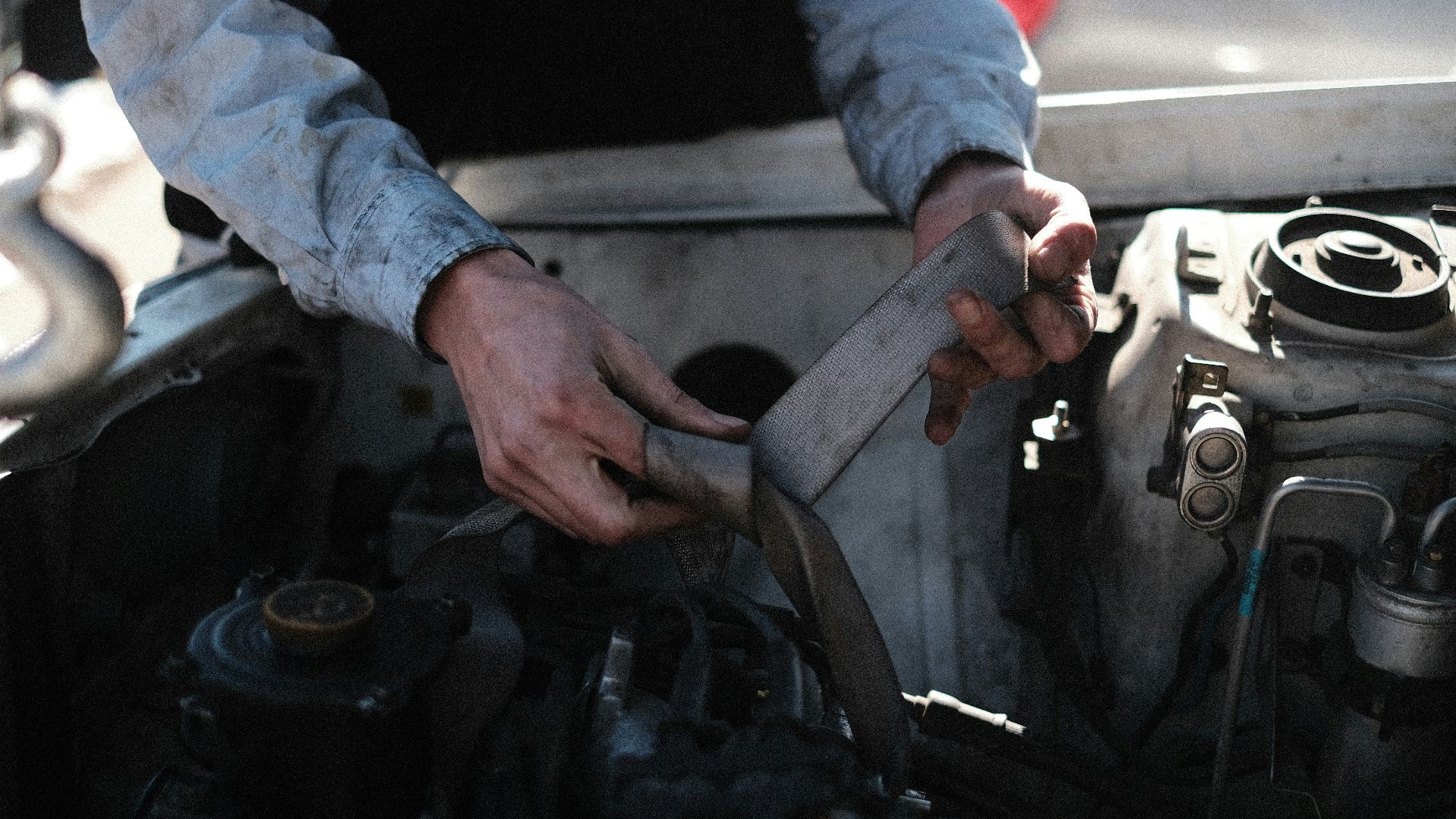 a man is working on a car engine