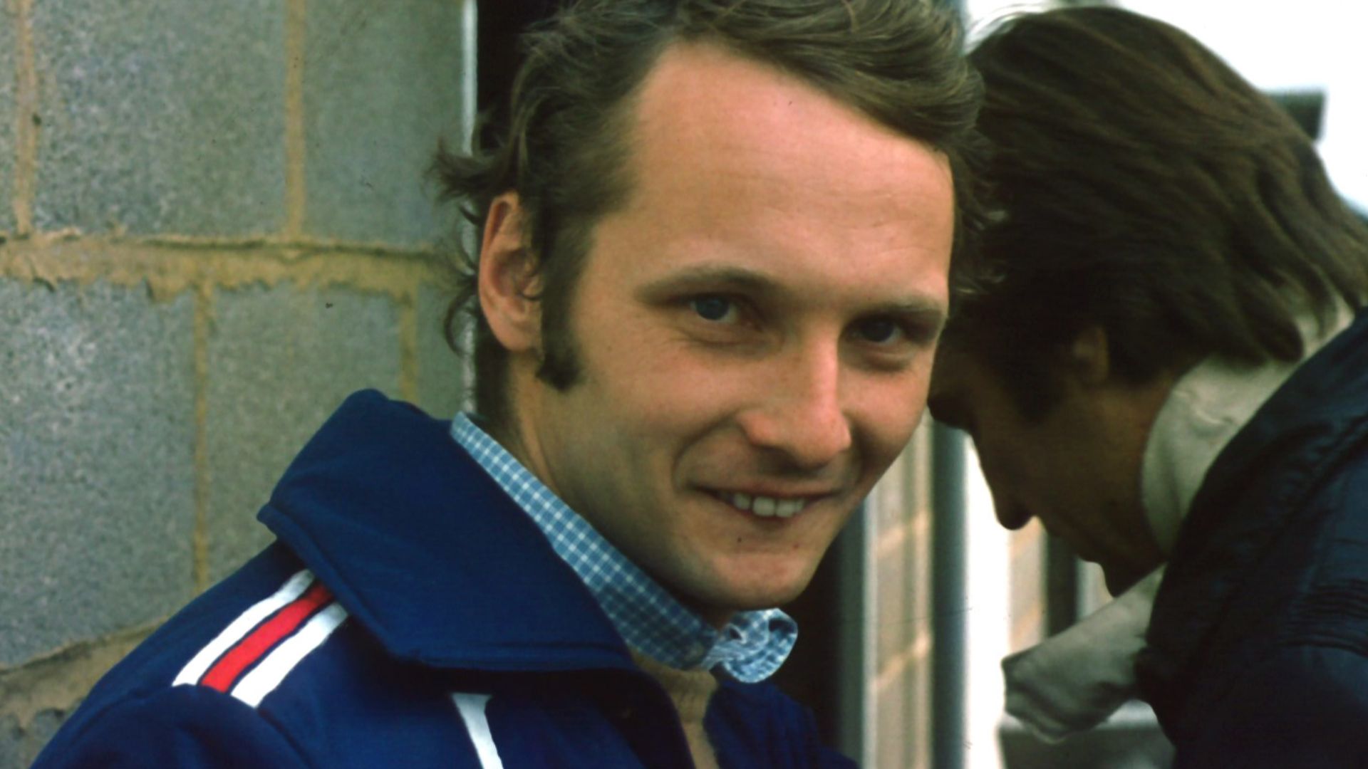 Niki Lauda while at Silverstone pitlane with Carlos Reutemann in background, 1975 British Grand Prix.