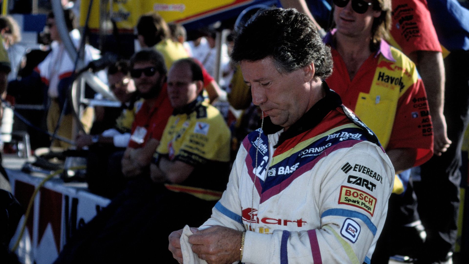 Mario Andretti, putting on his protective headmask before the start of the 1991 Monterey Grand Prix.