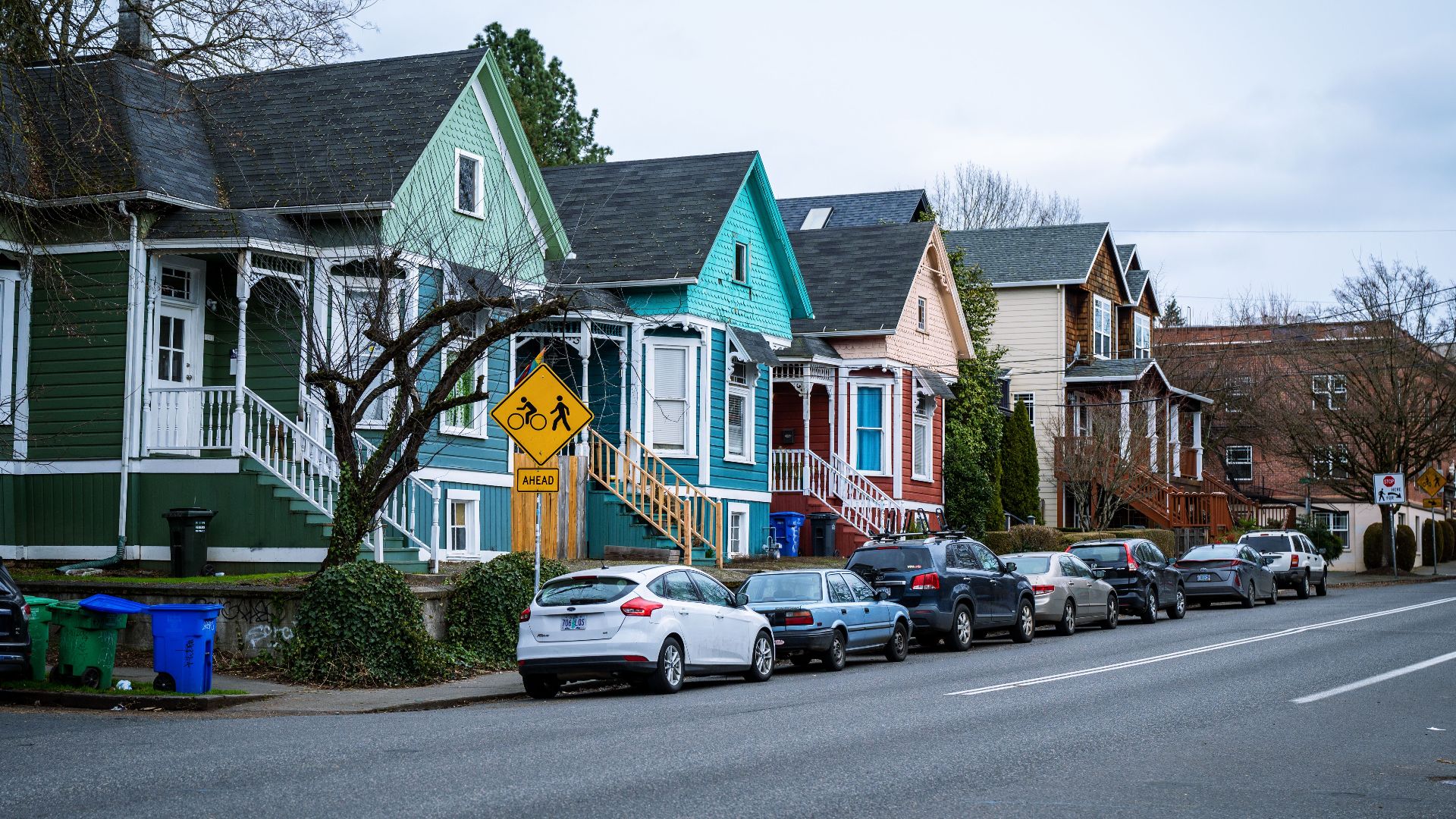 Picturesque street view of colorful, charming houses in a Portland, OR suburb, showcasing urban living.