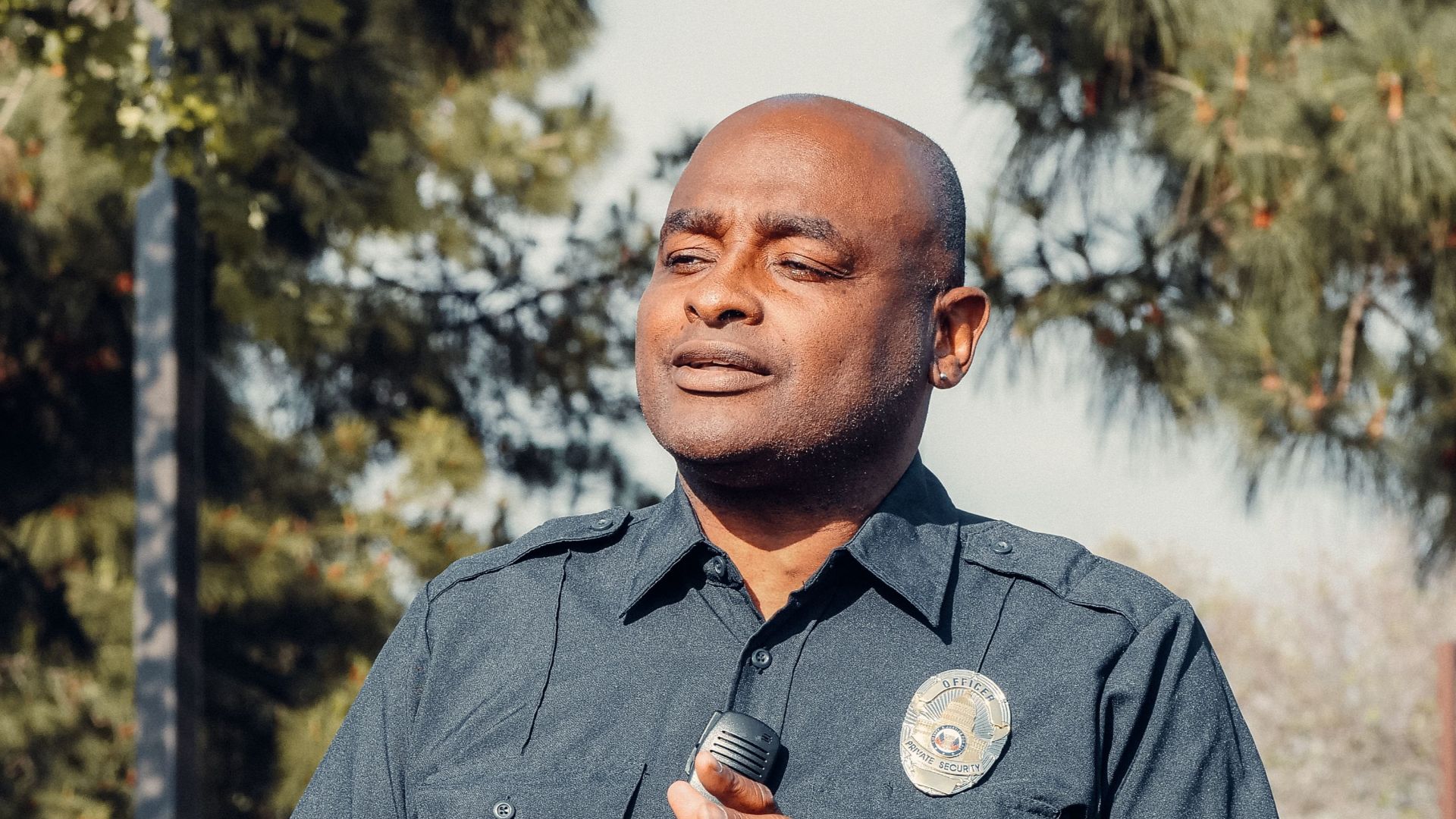 A police officer engages in conversation outdoors, reflecting community service and law enforcement.